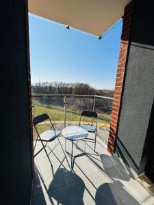 a patio with two chairs and a table on a balcony at Apartamenty Baltic Sea Wiedeńska 5 in Kołobrzeg