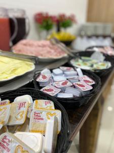 a table topped with lots of different types of food at Hotel Cidade Santa in Aparecida