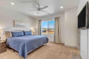 a bedroom with a blue bed and a window at Spacious 6-BR Retreat - Heated Pool Sleeps 16 in Santa Clara +27 photos