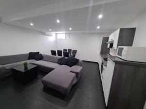 a living room with a couch and a microwave at HOUSE KOPER Center in Koper