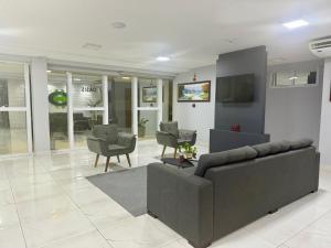 a living room with a couch and chairs in it at Hotel Oásis de Patos in Patos