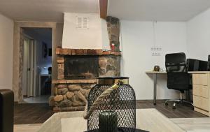a fireplace in a living room with a vase on a table at Baltā māja 56m2 in Tukums