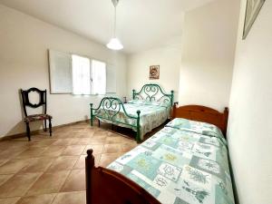 Ένα ή περισσότερα κρεβάτια σε δωμάτιο στο Villa Alghero mare 5 min