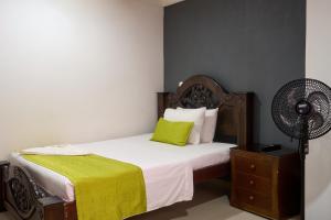 Rúm í herbergi á Hotel el imperio