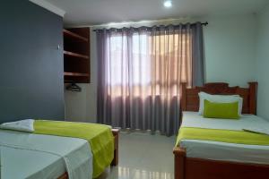 Rúm í herbergi á Hotel el imperio