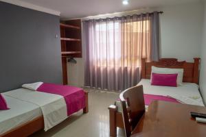 Rúm í herbergi á Hotel el imperio