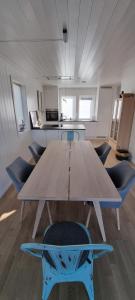 a large wooden table in a room with chairs at Lykkeli in Risør
