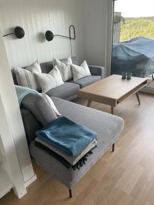 a living room with a couch and a table at Lykkeli in Risør