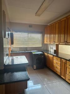 a kitchen with a washer and a stove in it at Revitalize in Springs