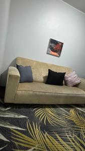 a couch in a living room with two pillows at HOPE-always in Cape Town