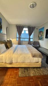 a bedroom with a large bed with a large window at HOPE-always in Cape Town