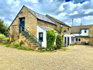 a stone house with a staircase in front of it at Foxhill in Barton