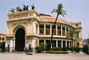 a building with a statue in front of it at Il Quadrifoglio Room& Suite in Palermo