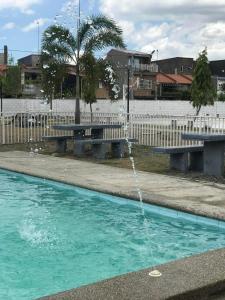 a swimming pool with a water fountain at Kellys Abode in Marilao +2 photos
