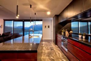 a kitchen with a large counter top with a view at Mountain Lake Vista 3 Bedroom in Queenstown