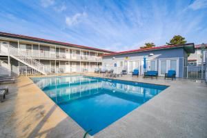 a swimming pool in front of a building at Walk to Ocean and Restaurants Biloxi Getaway! in Biloxi