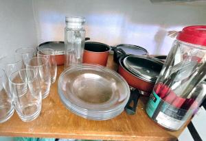 a wooden table with glasses and pots and pans at Jaboticabal 403A in Jabuticabal