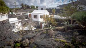 a white house on a hill with some plants at Casa volcánica El Cabezo in Masdache