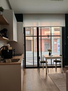 a kitchen with a table with two chairs and a table at Apartamento Diseño Myrtus in Ponteareas +15 photos