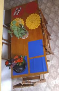 a table with a blue board and flowers on it at Hostel Aprisco São Paulo in São Paulo