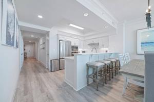 a kitchen and dining room with a table and chairs at Perdido Dunes Tower 2 East in Orange Beach