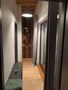 a hallway with a table and a door to a room at La Dolce vita in Sermersheim