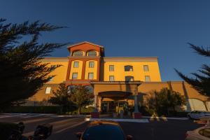 a yellow building with a car parked in front of it at Fiesta Inn Nogales in Nogales