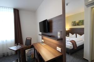 Postel nebo postele na pokoji v ubytování Trip Inn Goethe Conference Hotel