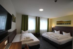Postel nebo postele na pokoji v ubytování Trip Inn Goethe Conference Hotel + 37 fotografií