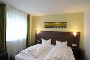 Postel nebo postele na pokoji v ubytování Trip Inn Goethe Conference Hotel