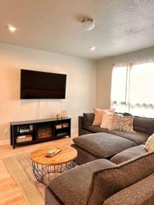 a living room with two couches and a flat screen tv at Newly Built Chic Utah Valley Gem l Theo in American Fork