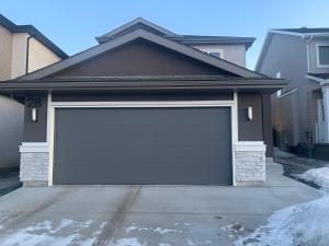 a garage door in front of a house at Luxury Private Suite with Separate Entrance in Winnipeg