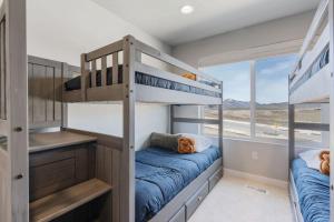 two bunk beds in a room with a window at Silver Creek Townhome with Hot Tub l Poppy in Park City