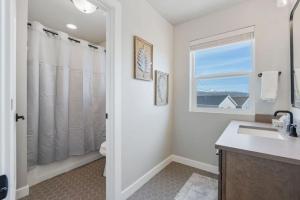 a bathroom with a sink and a window at Silver Creek Townhome with Hot Tub l Poppy in Park City +44 photos