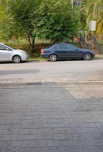 two cars are parked in a parking lot at Homestay Bandar Kajang in Kajang