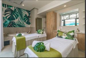 a room with two beds and a bath tub at 347 Waterfall Penthouse in Midrand +35 photos
