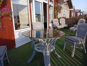 a glass table and chairs sitting on a patio at yeolde woodern country View seashak BONFIRE NOV SPECIALS FREE electric LOW PRICES ENJOY BRING YOUR DOG in Bridlington