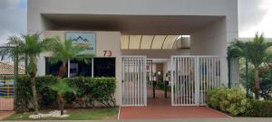 a building with a gate in front of it at Piatã apartamento com Clube in Salvador