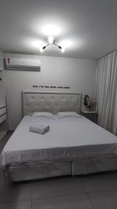 a bedroom with a large bed with a ceiling fan at Flat Studio in João Pessoa
