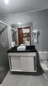 a bathroom with a sink and a toilet at Flat Studio in João Pessoa