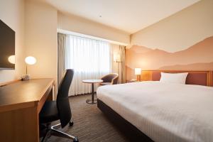 郡山Hotel Global View Premium Koriyama的配有床和书桌的酒店房间