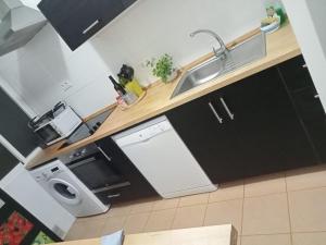 a kitchen with a sink and a stove and a microwave at Piso Barbate in Barbate