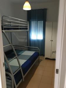 a bedroom with a bunk bed and a window at Piso Barbate in Barbate