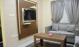 a living room with a couch and a table at تراس للشقق المخدومة in Dammam +6 photos