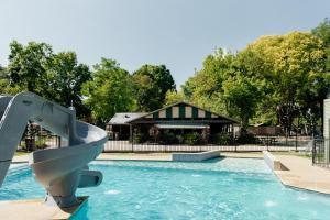 a water slide in a swimming pool with a building at Tasman Holiday Parks - South Bright in Bright