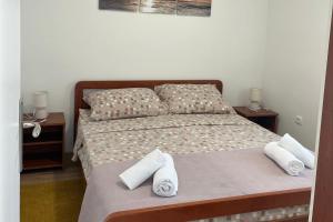 a bedroom with a bed with towels on it at Holiday house with a parking space Bilice, Krka - 24006 in Šibenik
