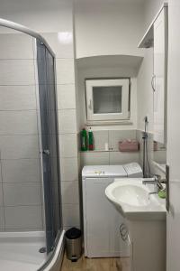 a white bathroom with a sink and a shower at Holiday house with a parking space Bilice, Krka - 24006 in Šibenik