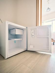 an open refrigerator with its door open in a room at vetta kumamoto suizenji 401 in Kumamoto