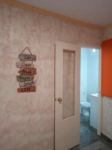 a bathroom with a sign that reads live dean whatilageilageilageverseverselez at La Tortuga Lodging RoomS in Tarifa +150 photos