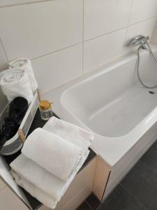a bathroom with a white bath tub with towels at Urlaub Oase in Coswig
